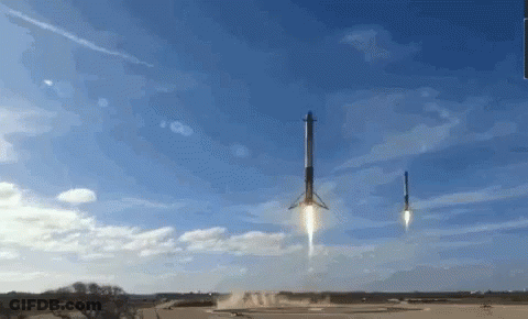 Two Rockets Are Being Launched Into The Sky With A Blue Sky In The Background GIF