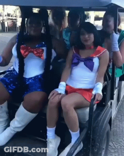 Two Sailor Moon Costumed Women In Golf Cart GIF