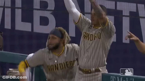 Two San Diego Baseball Players Are Celebrating With Their Hands In The Air GIF