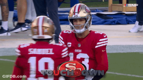 Two San Francisco 49Ers Football Players Are Talking On The Field GIF