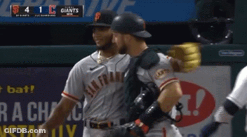 Two San Francisco Giants Players Are Hugging Each Other GIF