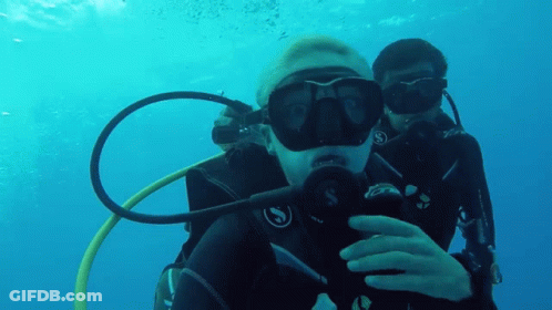 Two Scuba Divers Are Taking A Selfie In The Water GIF