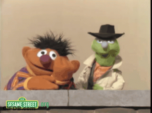 Two Sesame Street Characters Looking Over Wall GIF