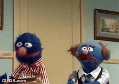 Two Sesame Street Characters Standing In Room GIF
