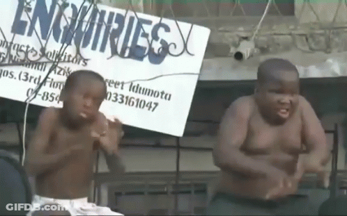 Two Shirtless Boys Dancing In Front Of Enquiries Sign GIF