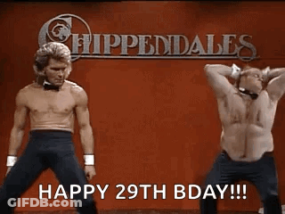 Two Shirtless Men Are Dancing In Front Of A Sign That Says Happy 29Th Bday . GIF