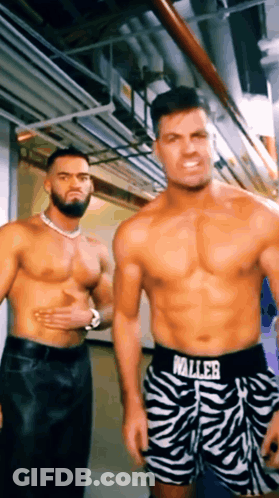 Two Shirtless Men Are Standing Next To Each Other In A Hallway Wearing Zebra Print Shorts That Say Waller GIF