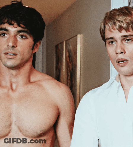 Two Shirtless Men Are Standing Next To Each Other GIF