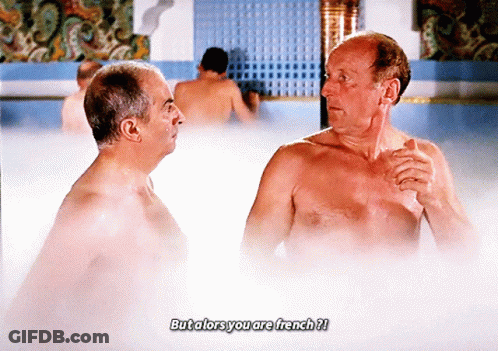 Two Shirtless Men Are Talking In A Bathtub With The Caption But Alors You Are French ? GIF