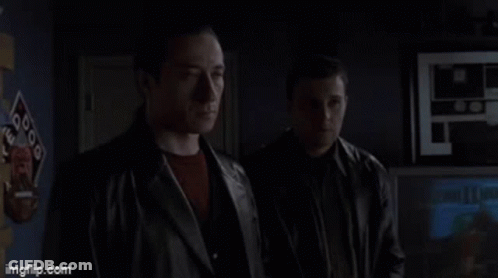 Two Shirtless Men In Dark Room With JVC Box GIF