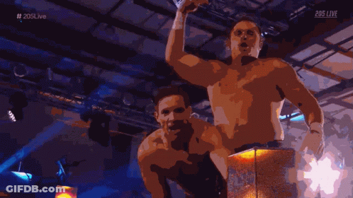 Two Shirtless Men In Front Of 203Live Screen GIF