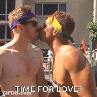 Two Shirtless Men Kissing At Pride Parade Saying Time For Love GIF