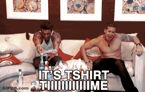 Two Shirtless Men Sit On A Couch With The Words It 'S Tshirt Time Written On The Bottom GIF