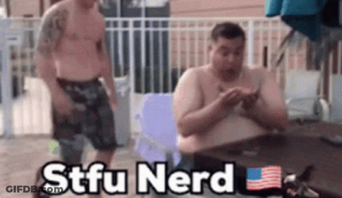 Two Shirtless Men Sitting At A Table With The Words Stfu Nerd Written On The Bottom GIF