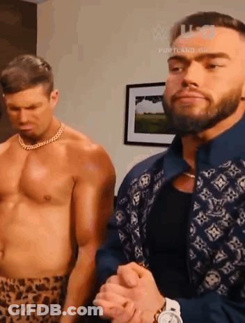 Two Shirtless Men Standing Next To Each Other In A Room . GIF