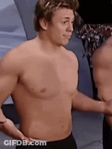 Two Shirtless Men Standing Together GIF