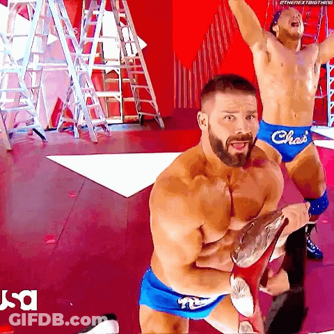 Two Shirtless Wrestlers In Blue Shorts With The Word Chas On Them GIF