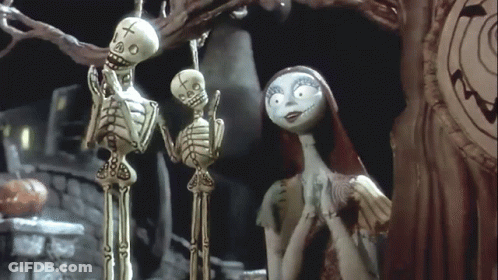 Two Skeletons One With Cross GIF
