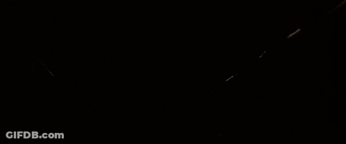 Two Skeletons Standing In Dark Room With Blue Light GIF