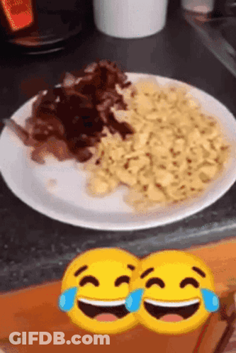 Two Smiley Faces Laughing Next To Plate Of Food GIF