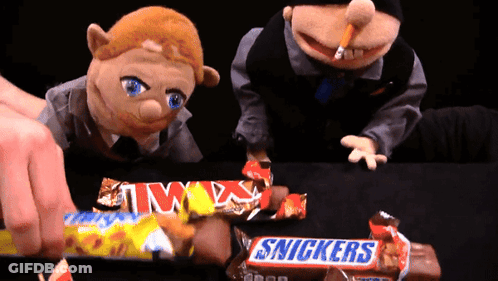Two Snickers Candy Bars Are Being Eaten By Two Puppets GIF