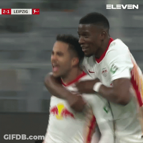 Two Soccer Players Are Celebrating A Goal Against Leipzig In A Stadium GIF