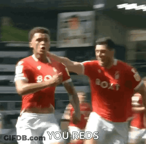 Two Soccer Players Are Celebrating A Goal And One Of Them Is Saying You Reds . GIF