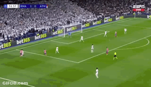 Two Soccer Players Are Celebrating A Goal During A Soccer Game . GIF