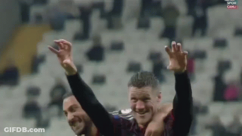 Two Soccer Players Are Celebrating With Their Arms In The Air And The Words Spor Canli On The Bottom GIF