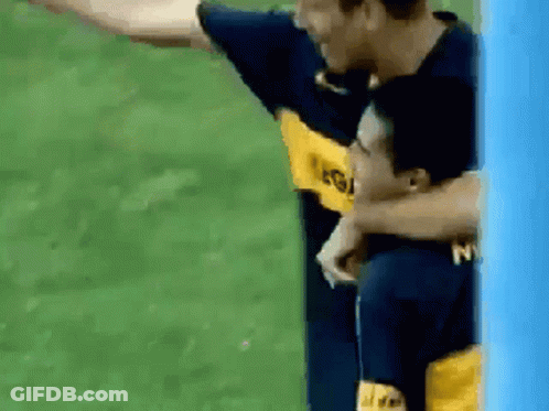 Two Soccer Players Are Hugging Each Other And One Has The Letter N On His Shirt GIF