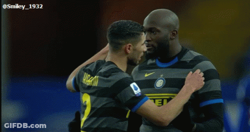 Two Soccer Players Are Hugging Each Other And One Has The Number 1 On His Shirt GIF