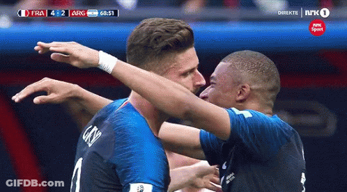 Two Soccer Players Are Hugging Each Other During A Game Sponsored By Nrk Sport GIF