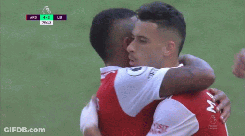 Two Soccer Players Are Hugging Each Other During A Game With The Score At 4-2 GIF