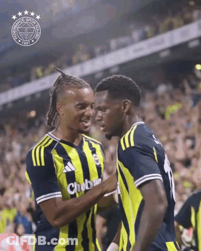 Two Soccer Players Are Hugging Each Other In Front Of A Crowd And One Of Their Shirts Says Chobar GIF