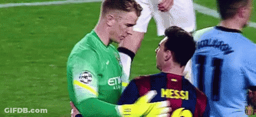 Two Soccer Players Are Hugging Each Other On A Field . GIF