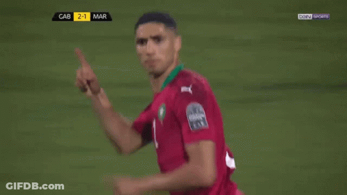 Two Soccer Players Are Hugging Each Other On A Field With Bein Sports On The Screen Behind Them GIF