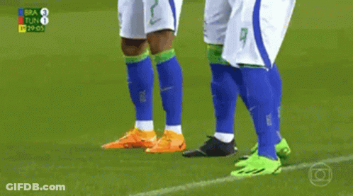 Two Soccer Players Are Hugging Each Other On A Field With The Number 2 On Their Shirts GIF