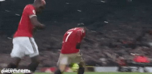 Two Soccer Players Are Kneeling Down On The Field . GIF