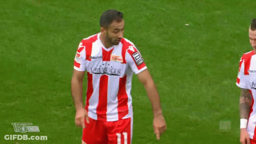 Two Soccer Players Are Making A Heart Shape With Their Fingers On The Field . GIF