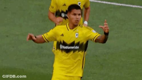 Two Soccer Players Are Making A Heart Shape With Their Hands On A Field . GIF