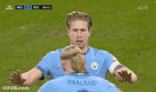 Two Soccer Players Are On A Field And One Has The Word Etihad On His Jersey GIF