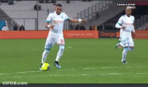 Two Soccer Players Are On A Field With An Orange Sign In The Background . GIF