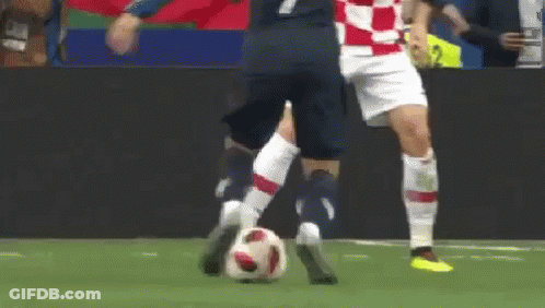 Two Soccer Players Are Playing A Game Of Soccer And One Of Them Is Kicking The Ball . GIF