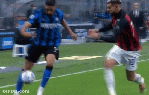 Two Soccer Players Are Playing A Game Of Soccer On A Field GIF