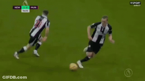 Two Soccer Players Are Playing A Game Of Soccer On A Soccer Field . GIF