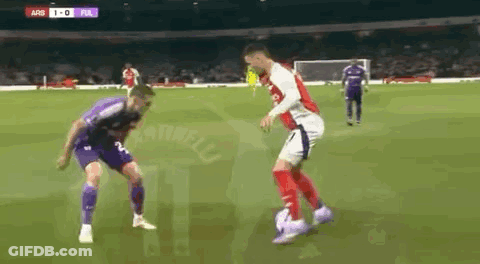 Two Soccer Players Are Playing A Game Of Soccer On A Soccer Field . GIF