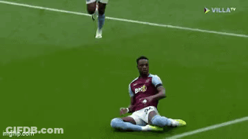 Two Soccer Players Are Running On A Soccer Field And One Of Them Is Wearing Shorts . GIF