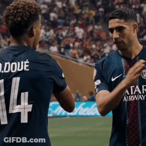 Two Soccer Players Are Shaking Hands And One Has The Number 14 On His Jersey GIF