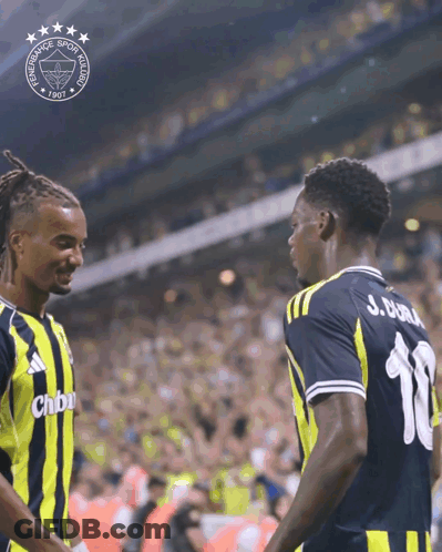 Two Soccer Players Are Shaking Hands In Front Of A Logo That Says Fenerbahce GIF