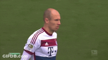 Two Soccer Players Are Shaking Hands On The Field And One Has The Number 12 On His Shirt GIF